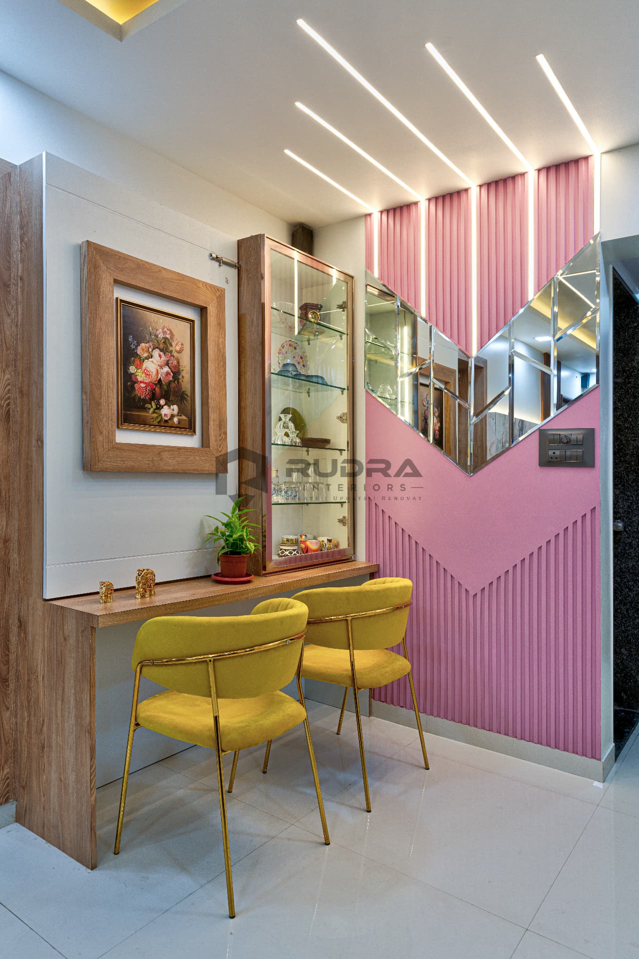 Pink fluted accent wall with mirror panels and console seating
